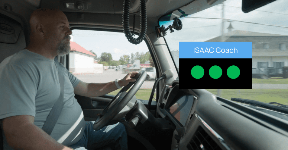 Truck driver in cab with ISAAC Coach overlay showing three green circles.