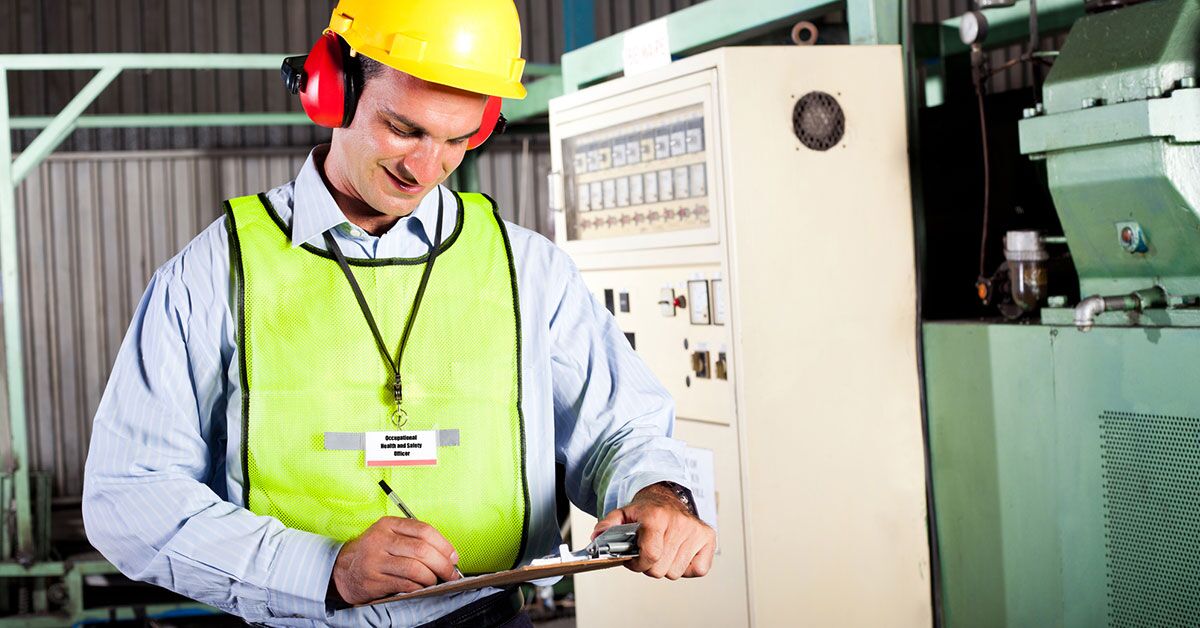 The Impact of Workplace Safety on Employee Morale Smiling worker wearing a hard hat, safety vest, and ear protection to demonstrate proper safety and employee satisfaction on a job site.